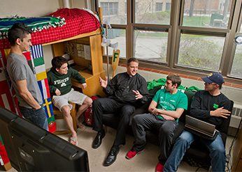 Fr Brad Metz, CSC talking with residents of Fisher Hall