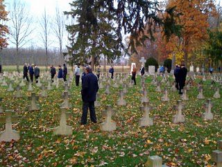 Holy Cross priests walk among the headstones