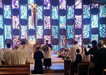 Br DeAgostino, CSC receives a blessing at a Community Mass