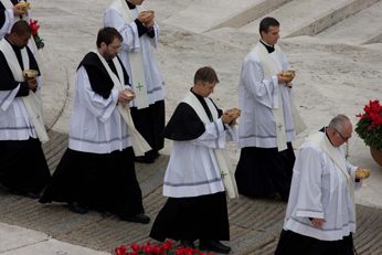 Fr Eric Schimmel, CSC giving communion at the canonization of Saint Andre