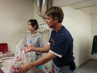 Fr Eric Schimmel, CSC handing out clothes
