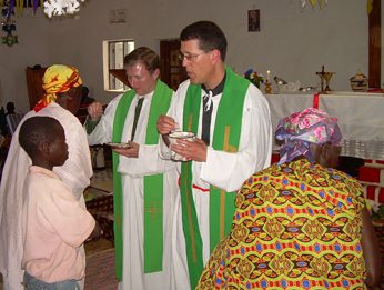 Fr Paul Kollman, CSC giving Communion