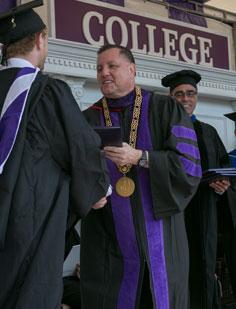 Father Mark Cregan giving a degree