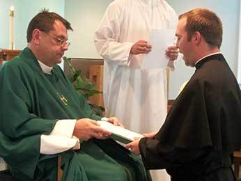 Fr Szakaly, CSC receives Deacon Tim Mouton, CSC's renewal of vows