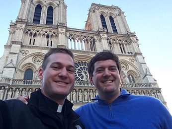Drew Clary with Fr Nate Wills, CSC in front of the Notre Dame Cathedral