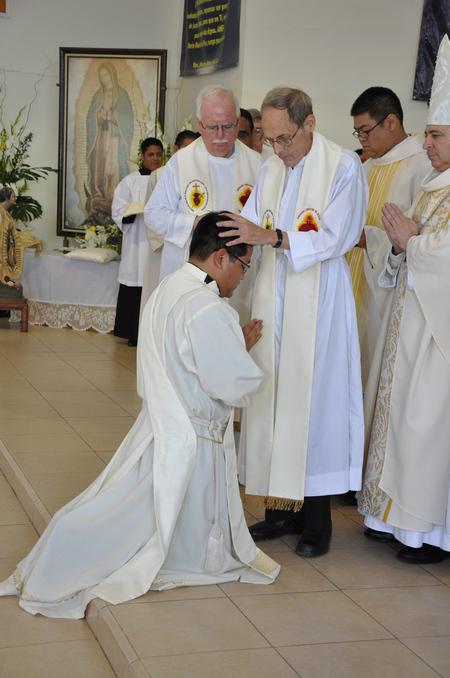 Father Dan Panchot lays his hands on Fr