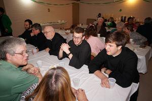 Father OHara and some of the Novices have dinner with parishioners at TriCommunity Parish