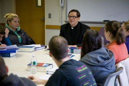 Father Piggford teaching at Stonehill Collgege