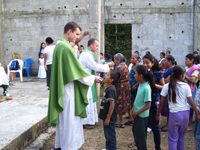 Fr Aaron Michka, CSC giving communion in Mexico