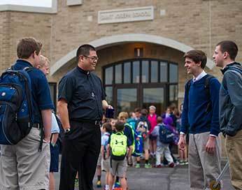 Fr Brian Ching, CSC speaking with students