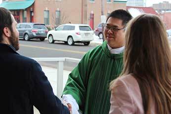 Fr Brian Ching, CSC with Parishioners