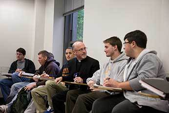 Fr Dan Issing, CSC with students at King's College