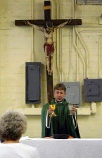 Fr Eric celebrating Mass at Andre House