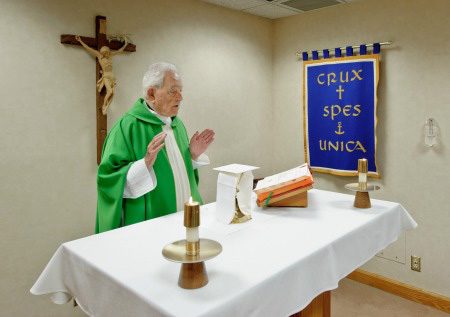 Father Theodore Hesburgh says Mass in his office chapel