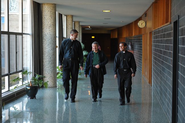 Holy Cross Priests Walking in Corridor at Moreau Seminary