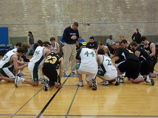 Coach Fr Pete McCormick, CSC, leading a post game prayer
