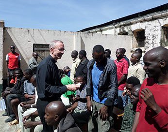Fr Jim Phalan, CSC sharing Rosaries in Nairobi