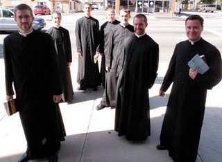 The soon to be professed line up in cassocks before mass