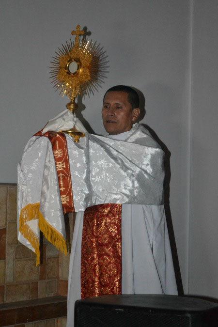 Father Anibal Nino with the Blessed Sacrament during the candlelight vigil for 50 years of Holy Cross in Peru on September 14
