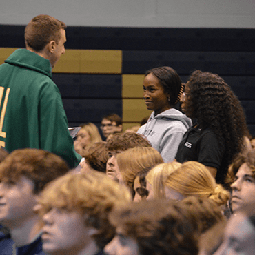 CSC priest with students from a CSC high school at Mass