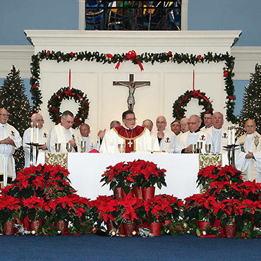Holy Cross priests concelebrate with Bishop Bud in 2016