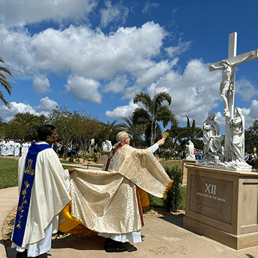 Priests revere crucifix at St. John the Evangelist in Viera, Florida