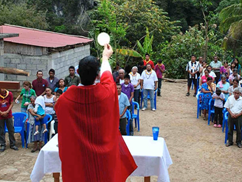 Fr Matt Kuczora raises the host at Mass in Xomoco, Mexico