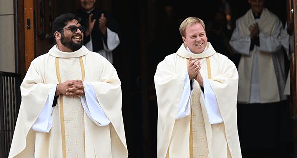 Fr. Andrew Fritz, C.S.C. and Fr. John Sebastian Gutierrez, C.S.C., exit the Basilica of the Sacred Heart following their ordination to the priesthood in 2023