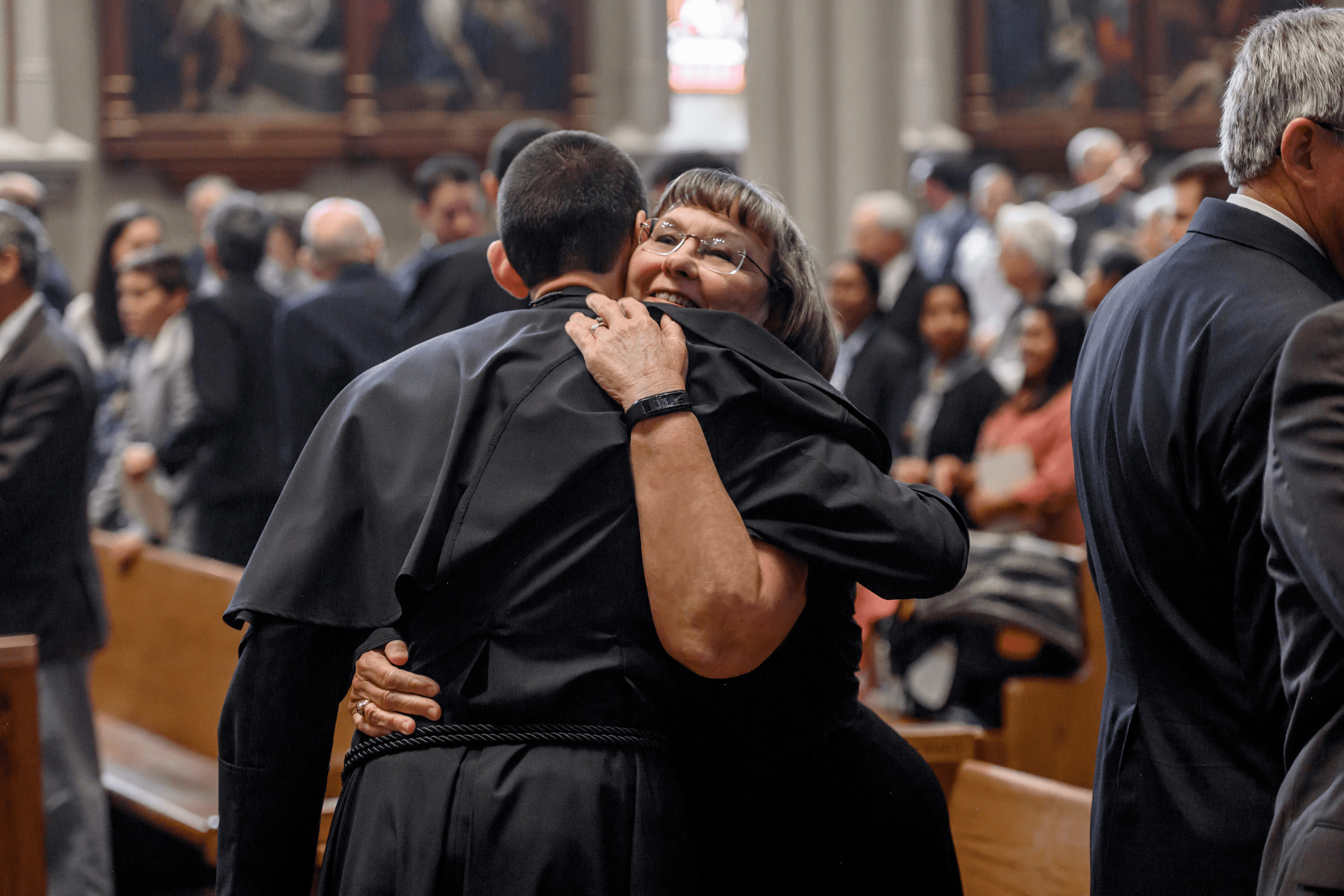 Mrs. Rathke embraces her son, Fr. Zach Rathke CSC, at his ordination