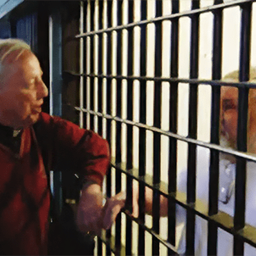 Fr Tom McNally talking with a prisoner