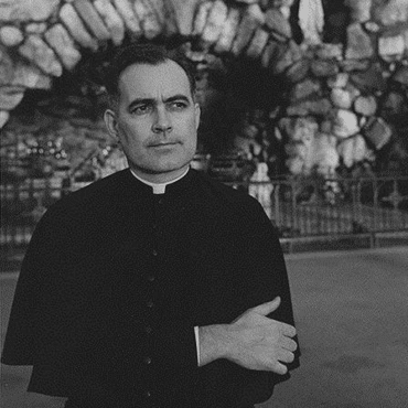 Fr. Ted Hesburgh, CSC in front of the Grotto of Our Lady of Lourdes at the University of Notre Dame