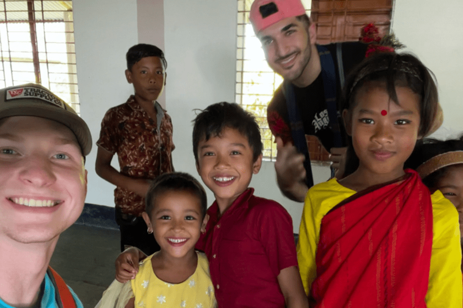 Caden Reader with children in Bangladesh
