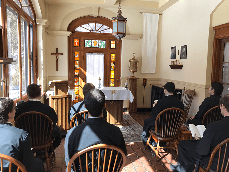 Men praying in novitiate chapel