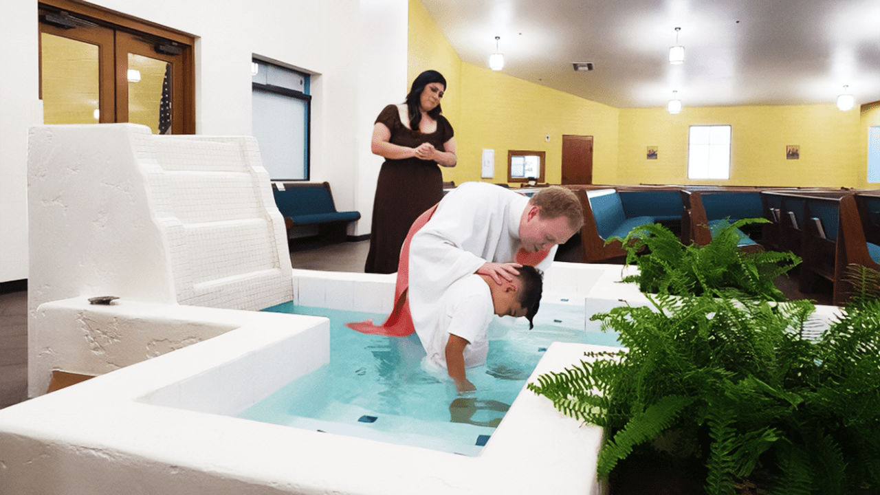 Fr. Andrew Fritz, C.S.C., baptizing a child at St. John Vianney Catholic Church in Goodyear, Arizona