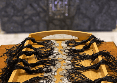 Miraculous Medals for football players in front of King's College's anthracite altar