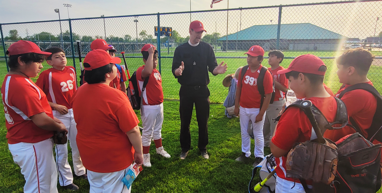 Br. Matt coaching baseball at St. Adalbert's Catholic School