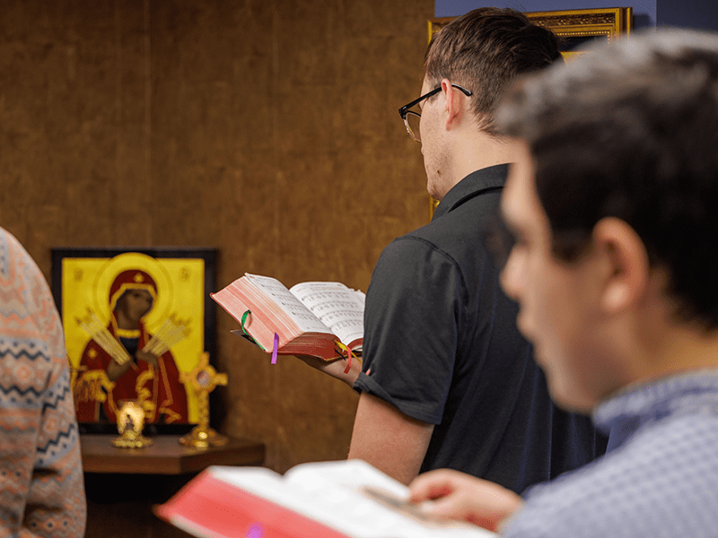 Collegian praying