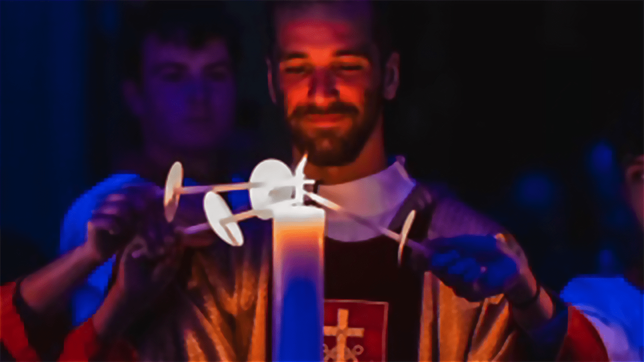 Deacon Steve Jakubowski, C.S.C., lighting candles at the Easter Vigil