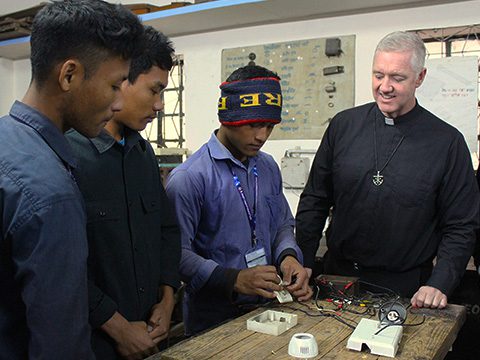 Fr Matt Kuczora raises the host at Mass in Xomoco, Mexico