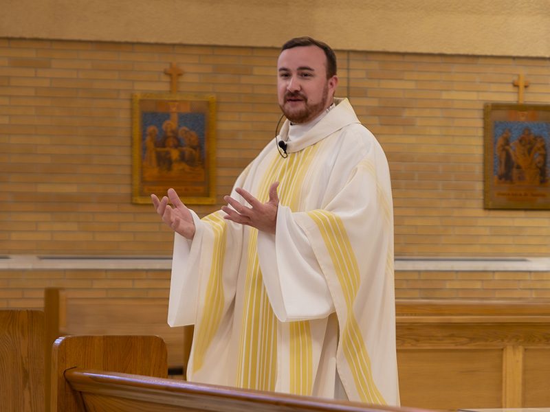 2025 Fr David Smith Fr. Paul Ybarra raises consecrated host