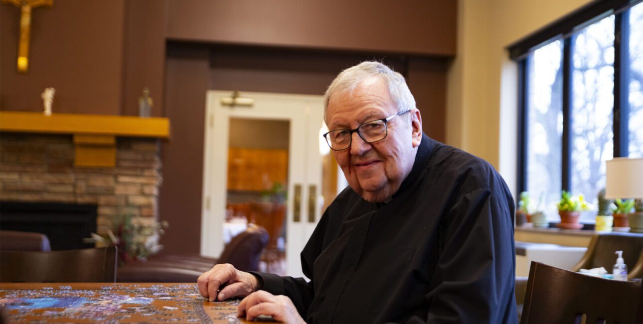 Two men in formation lie prostrate during their profession of perpetual vows
