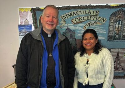 Fr. Neil Wack and Outreach Coordinator Maria Kangapadan are pictured standing outside of Immaculate Conception parish.