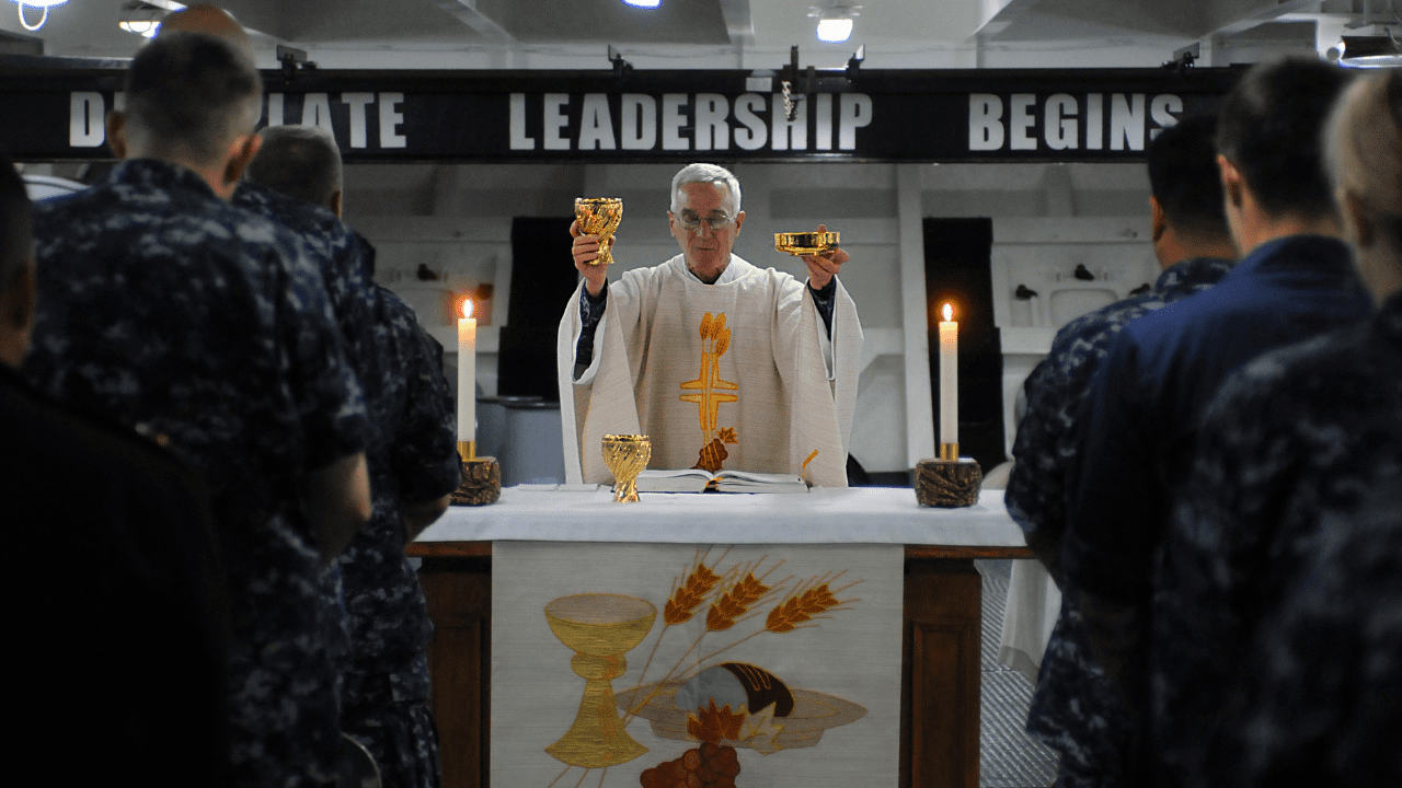 Fr. Dorwart is praying over the Eucharist at a Navy chapel.