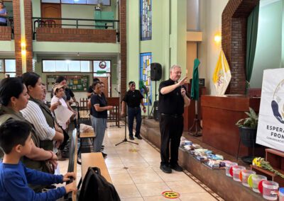 Fr. Tom Eckert blesses items that volunteers will distribute to the community during the Chile-Peru Missionary Outreach