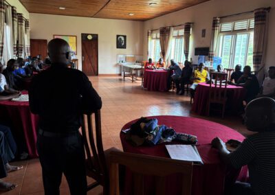 Fr. Arnold speaking to postulants at St. Andre Bessette Postulant Formation House in Bugembe, Jinja, Uganda - Bro. Patrick Mugabo, C.S.C., at table