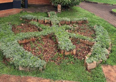 St. Andre Bessette Postulate Formation House with a logo formed into the shrubbery