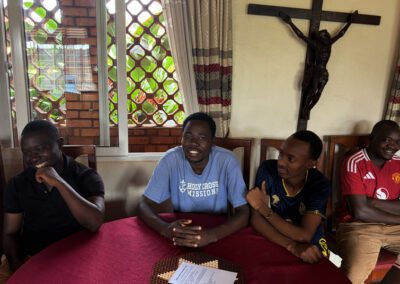 St. Andre Bessette Postulate Formation House Men In Formation gathered around a table conversing