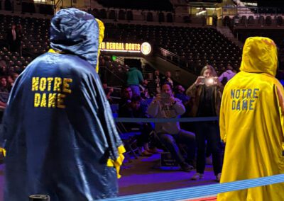 University of Notre Dame male and female boxer walking onto the boxing ring at an event.