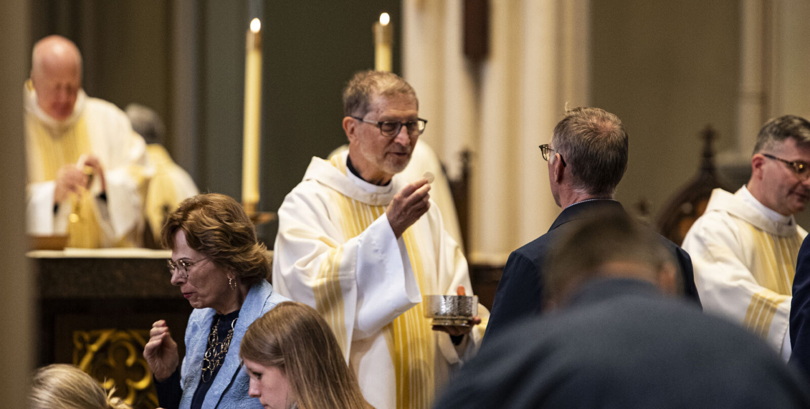 Fr. Frank Zlotkowski, C.S.C., is pictured distributing communion at the 2026 jubilee Mass.