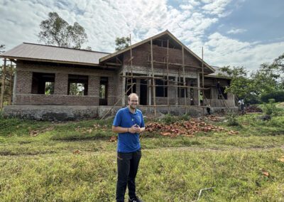 Mr. Keenan Bross, C.S.C. Keenan is pictured at a building site assisting with plans for a new school supported by the Holy Cross Mission Center in partnership with the Institute for Educational Initiatives.
